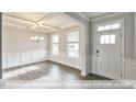 Charming dining room boasting natural light, coffered ceilings, wainscoting, and beautiful hardwood floors at 405 Falls Bluff Dr, Wake Forest, NC 27596