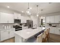 Spacious kitchen featuring a large island with bar seating and stainless steel appliances at 465 Grange Farm Pl, Raleigh, NC 27603