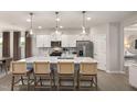 Well-lit kitchen with a large island, pendant lights, and stainless steel appliances at 465 Grange Farm Pl, Raleigh, NC 27603