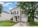 Traditional exterior elevation with manicured front lawn, garage, and mature trees at 4712 Rockport Dr, Durham, NC 27703