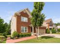 Attractive brick home featuring a landscaped yard and a two-car garage at 5028 Blue Jack Oak Dr, Cary, NC 27519
