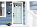Charming home exterior with blue siding, a mint front door, and stylish address number at 507 Rosengarten Aly, Raleigh, NC 27603