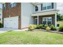 Well maintained lawn with garden beds frames the front of this charming brick and vinyl home at 514 Alamanni Ct, Graham, NC 27253