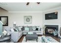 Comfortable living room featuring a corner fireplace, plush seating, and a modern design at 514 Alamanni Ct, Graham, NC 27253