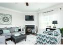 Bright living room with a corner fireplace, comfortable seating, and plenty of natural light at 514 Alamanni Ct, Graham, NC 27253