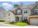 Beautiful two-story home with stone accents, a two-car garage, and well-maintained landscaping at 5421 Brandy Bay Rd, Raleigh, NC 27613