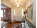 Inviting foyer featuring a beautiful hardwood floor, a hall bench, and bright decor at 6717 Valley Dr, Raleigh, NC 27612