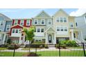 Charming townhome exterior with lush landscaping and well-manicured lawn at 713 Traditions Grande Blvd, Wake Forest, NC 27587