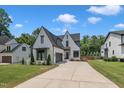 Striking exterior view showcasing a spacious driveway, manicured lawn, and elegant architectural design at 800 Wilcox St, Raleigh, NC 27607