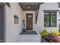 Inviting front entrance with a stylish dark wood door, modern lighting, and attractive landscaping at 800 Wilcox St, Raleigh, NC 27607