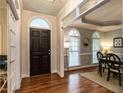 Elegant foyer with hardwood floors, arched doorway, and dining area with a chandelier at 820 Parkridge Dr, Clayton, NC 27527
