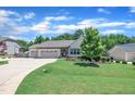 Lovely one-story home with attached two car garage and a lush front lawn and driveway at 85 Willard Wood Run, Benson, NC 27504