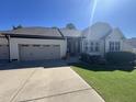 Charming single-story home boasts an attached two-car garage and a well-manicured front lawn with landscaping at 85 Willard Wood Run, Benson, NC 27504