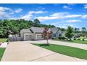 Spacious home with a three-car garage, long driveway, and manicured lawn at 85 Willard Wood Run, Benson, NC 27504