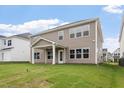 Expansive backyard with lush green grass and a covered patio, perfect for outdoor entertaining at 94 Black Walnut Dr # 201, Garner, NC 27529