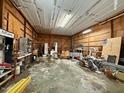 Large garage interior with concrete floor and wood plank walls, a versatile space for hobbies or storage at 94 S Waters Edge Ln, Henderson, NC 27537