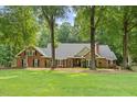 Stately brick home with manicured lawn and mature trees at 9940 Koupela Dr, Raleigh, NC 27614
