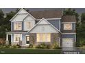 A beautiful two-story home with a mix of stone and siding, plus a well-maintained lawn and landscaping at Tbd Lot 11 Montgomery Estates Rd, Hillsborough, NC 27278