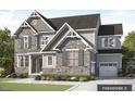 An elegant two-story home featuring a stone facade, complemented by gray shutters and a landscaped front yard at Tbd Lot 11 Montgomery Estates Rd, Hillsborough, NC 27278