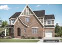 A charming brick two-story home with a prominent arched entryway and a well-manicured lawn at Tbd Lot 11 Montgomery Estates Rd, Hillsborough, NC 27278