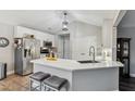 Modern kitchen with white cabinets, stainless steel appliances, and a breakfast bar with seating at 10 Oxford Dr, Angier, NC 27501
