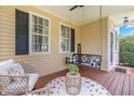 Cozy front porch featuring a porch swing, comfortable seating, and natural light at 100 Fountain Springs Rd, Holly Springs, NC 27540