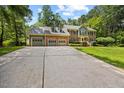 Inviting home with a large driveway, lush lawn, and a welcoming brick facade at 1005 Enderbury Dr, Raleigh, NC 27614