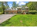 Attractive brick home with a well-manicured lawn and an attached three-car garage at 1005 Enderbury Dr, Raleigh, NC 27614