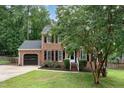 Charming brick two-story home with black shutters, landscaped front yard, and attached garage at 1006 Mingo Pl, Knightdale, NC 27545