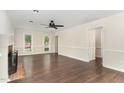 Open-concept living area with wood floors, neutral walls, and views into other rooms at 1006 Mingo Pl, Knightdale, NC 27545