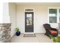 Inviting front porch with cozy seating and a beautifully detailed front door at 1109 Briar Gate Dr, Holly Springs, NC 27540