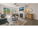 Cozy living room featuring fireplace, tv, hardwood floors and comfortable seating at 1109 Briar Gate Dr, Holly Springs, NC 27540