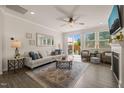Bright living room featuring hardwood floors, neutral decor, and a sliding glass door to patio at 1109 Briar Gate Dr, Holly Springs, NC 27540