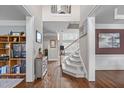 Inviting foyer featuring hardwood floors, staircase, and views into multiple rooms, creating an open and airy feel at 111 Revere Forest Ct, Cary, NC 27519