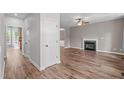 Open-concept living room featuring hardwood floors and a fireplace at 1111 Barrow Nook Ct, Apex, NC 27502