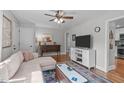 Comfortable living room with stylish rug, ceiling fan, and a view into the kitchen at 1209 Edgevale Rd, Durham, NC 27701