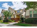 Beautiful exterior view of a two-story home with yellow siding, brick accents, and lush landscaping at 1304 Rodessa Run, Raleigh, NC 27607