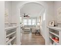 Inviting living room with archway entry, hardwood floors, and a comfortable sofa at 1304 Rodessa Run, Raleigh, NC 27607