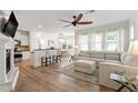 Bright living room featuring a fireplace, hardwood floors, and a seamless transition to the dining area at 1304 Rodessa Run, Raleigh, NC 27607