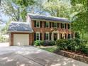 Traditional brick home with attached garage, long driveway, and manicured landscaping at 1304 Sandpiper Ct, Raleigh, NC 27615