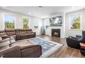 Inviting living room features a cozy fireplace, plush seating, and large windows for ample natural light at 132 Yellow River Way, Garner, NC 27529
