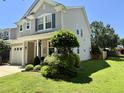 Exterior view of a well-maintained home with green lawn and mature landscaping in a suburban neighborhood at 137 Palmdale Ct, Holly Springs, NC 27540