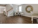 Inviting living space featuring stylish decor, wood floors, and a staircase at 137 Palmdale Ct, Holly Springs, NC 27540