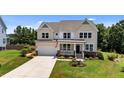 Beautiful two-story home showcasing manicured landscaping and a welcoming front porch at 185 Twilight Trl, Willow Springs, NC 27592