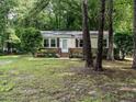 Attractive single-story home with a brick foundation, an American flag, and a well-maintained front lawn at 203 Lane Of Sir Kay, Garner, NC 27529
