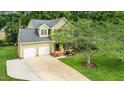 Scenic aerial view of a well-maintained home with a long driveway and beautifully landscaped yard at 2218 Watersglen Dr, Apex, NC 27502