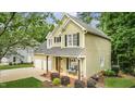 Charming two-story home featuring a cozy front porch and a two-car attached garage at 2218 Watersglen Dr, Apex, NC 27502