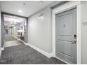 Apartment hallway with carpet and door to unit 213 at 222 Glenwood Ave # 213, Raleigh, NC 27603
