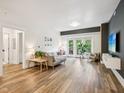 Sun-lit living room featuring stylish decor, wood floors, and a cozy gray sofa at 222 Glenwood Ave # 213, Raleigh, NC 27603
