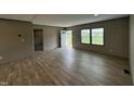 Bright living room featuring wood-look flooring, neutral walls, and a welcoming entry at 2232 Tarboro Road Rd, Youngsville, NC 27596